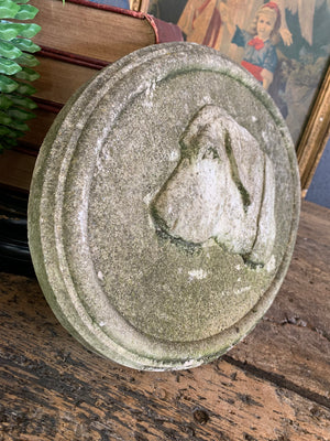 An oval cast stone plaque depicting a dog's head in profile ~B