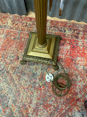 A brass Corinthian column standard lamp on lion paw feet