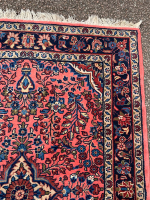 A Persian pink ground wool rug ~ 155cm x 105cm