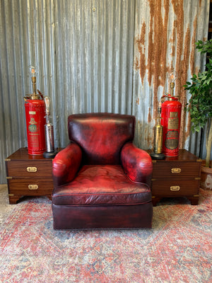 An oxblood red leather club chair