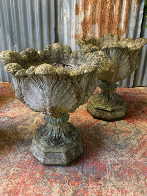 A pair of large acanthus cast stone urns