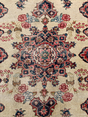 A Persian cream ground rug ~ 194cm x 133cm