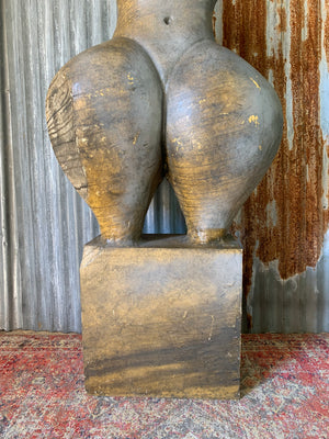 An oversized sculpture of a female nude