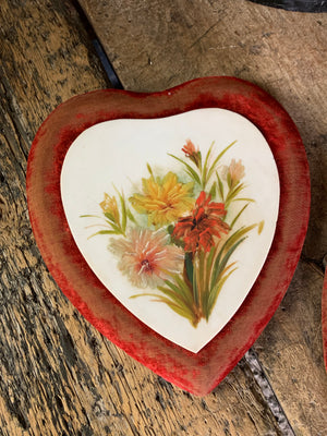 A pair of Victorian porcelain heart plaques on red velvet mounts