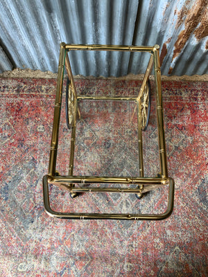 A faux bamboo Hollywood Regency two tier trolley