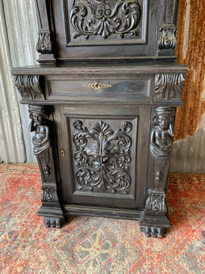 A heavily carved ebonised oak Gothic dresser