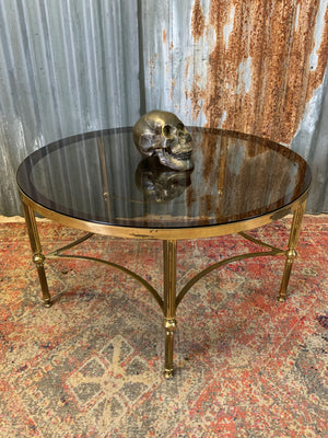 A rare circular brass and glass Hollywood Regency coffee table