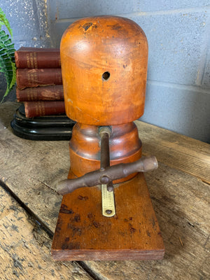 A wooden millinery hat stretcher