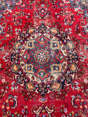 A large red ground Persian rug - 299cm x 194cm