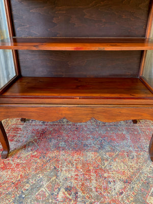 A mahogany double-fronted glass display cabinet with two drawers