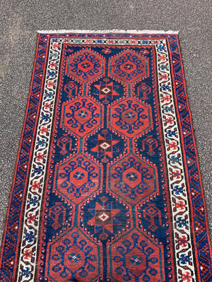 A long red ground blue Persian runner rug ~ 304cm x 104cm