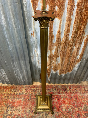 A brass Corinthian column standard lamp on lion paw feet