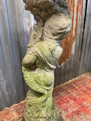 A neoclassical cast stone birdbath with cherub and fish design