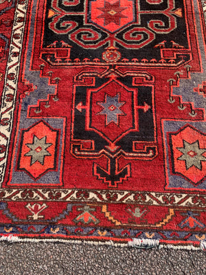 A Turkish red ground rug ~ 211cm x 138cm