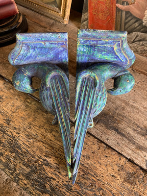 A pair of wooden corbels in the form of parrots