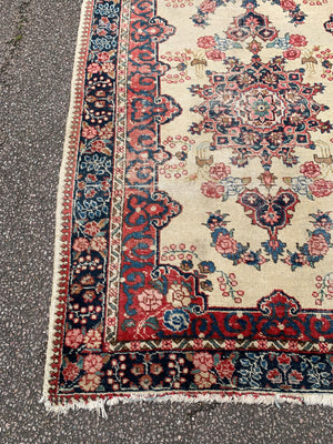 A Persian cream ground rug ~ 194cm x 133cm