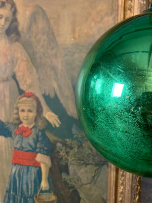 A large green mercury glass witches ball