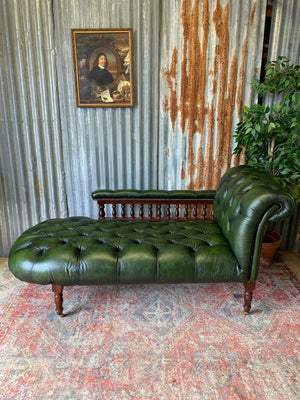 A Victorian-style green leather chaise longue