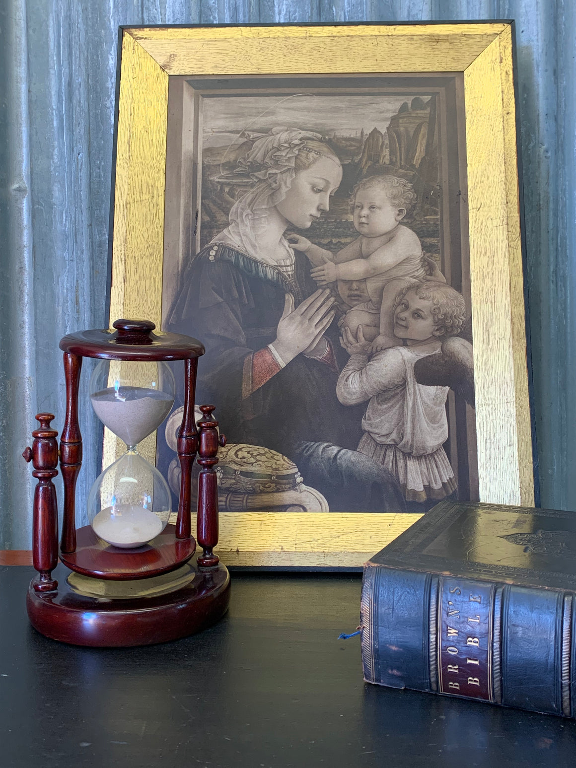 A mahogany rotating hourglass or sand timer
