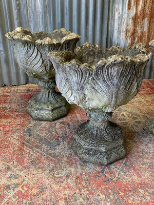 A pair of large acanthus cast stone urns