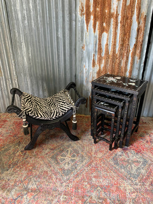 A nest of four black lacquered chinoiserie tables