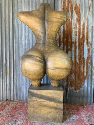 An oversized sculpture of a female nude