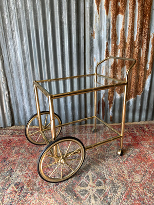 A faux bamboo Hollywood Regency two tier trolley