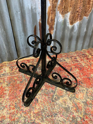 A pair of wrought iron Gothic candlesticks