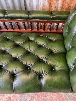 A Victorian-style green leather chaise longue