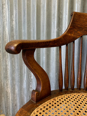 A banker's chair with caned seat