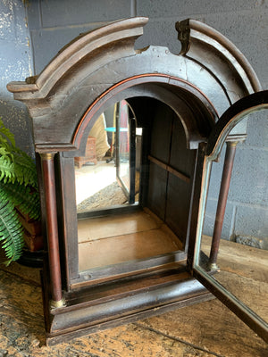 A grandfather clock case display cabinet