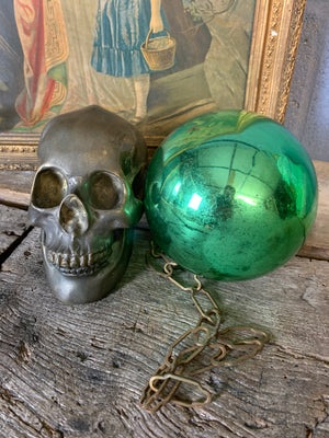 A large green mercury glass witches ball