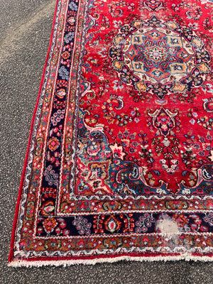 A large red ground Persian rug - 299cm x 194cm