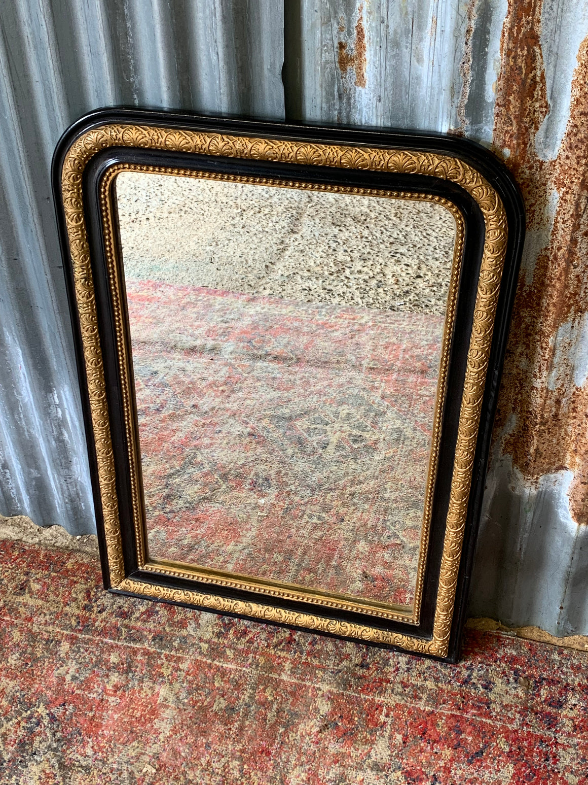 A large French black and gold mirror