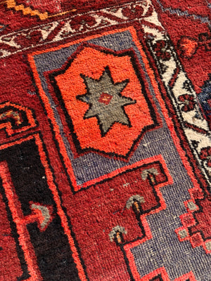 A Turkish red ground rug ~ 211cm x 138cm