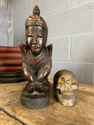 A carved wooden Manussiha sphinx statue