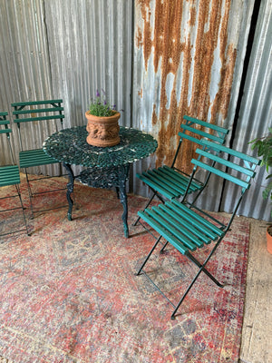 A green garden table and chairs set