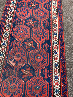 A long red ground blue Persian runner rug ~ 304cm x 104cm