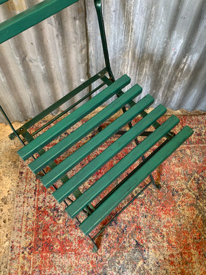 A green garden table and chairs set