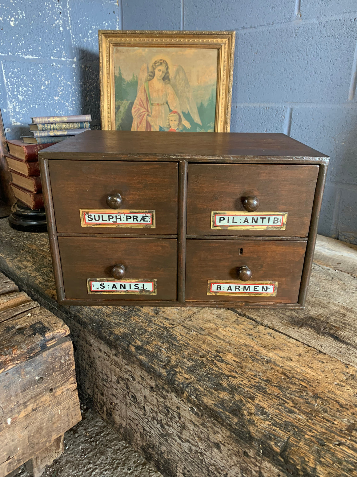 A bank of 4 apothecary drawers with Latin glass labels