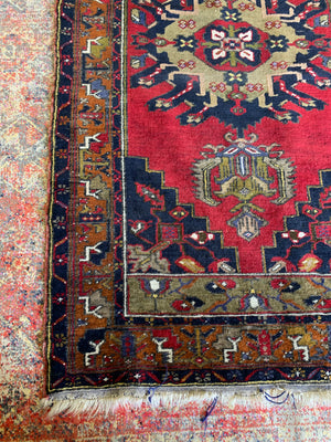 A Turkish red ground rug - 198cm x 105cm