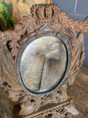 A cast iron table top mirror