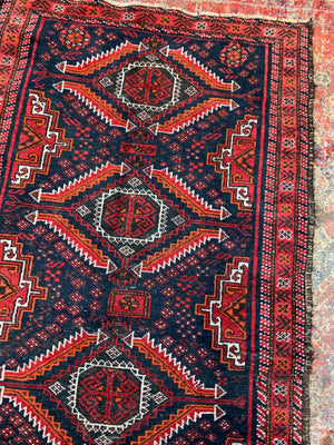 A Persian red & blue ground rectangular rug ~ 179cm x 96cm