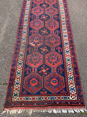 A long red ground blue Persian runner rug ~ 304cm x 104cm