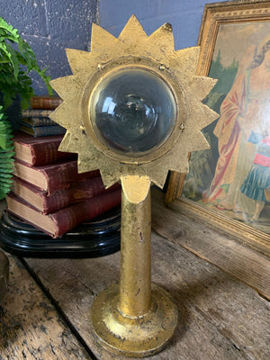 A gilt refraction candlestick with sunburst detail