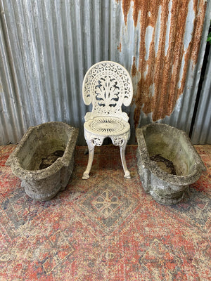 A pair of cast stone trough planters