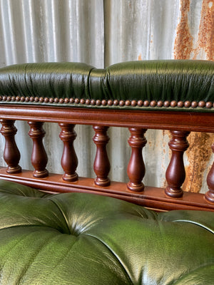 A Victorian-style green leather chaise longue