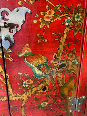 A red and gold lacquered chinoiserie cabinet