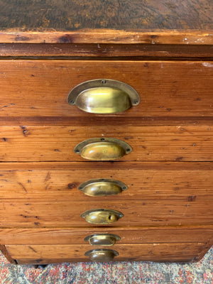 A pine chest of six drawers on castors