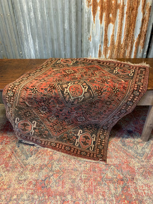 A Persian red ground rectangular rug- 161cm x 117cm